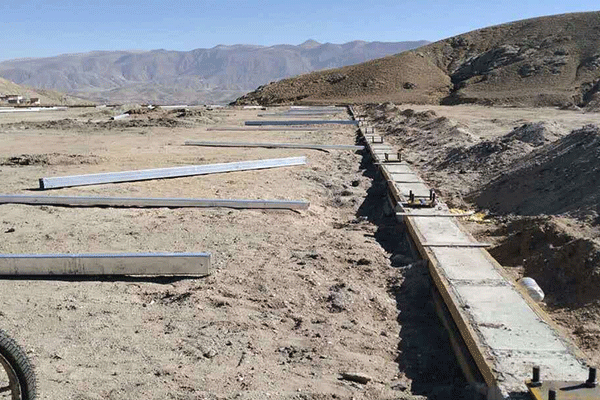 A large glass greenhouse under construction