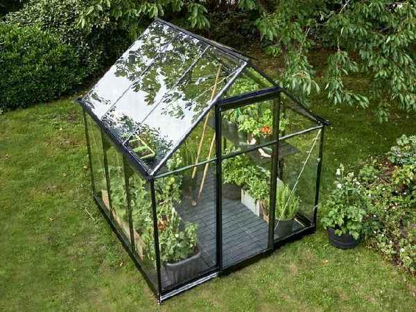 Small even-span greenhouse in a home garden